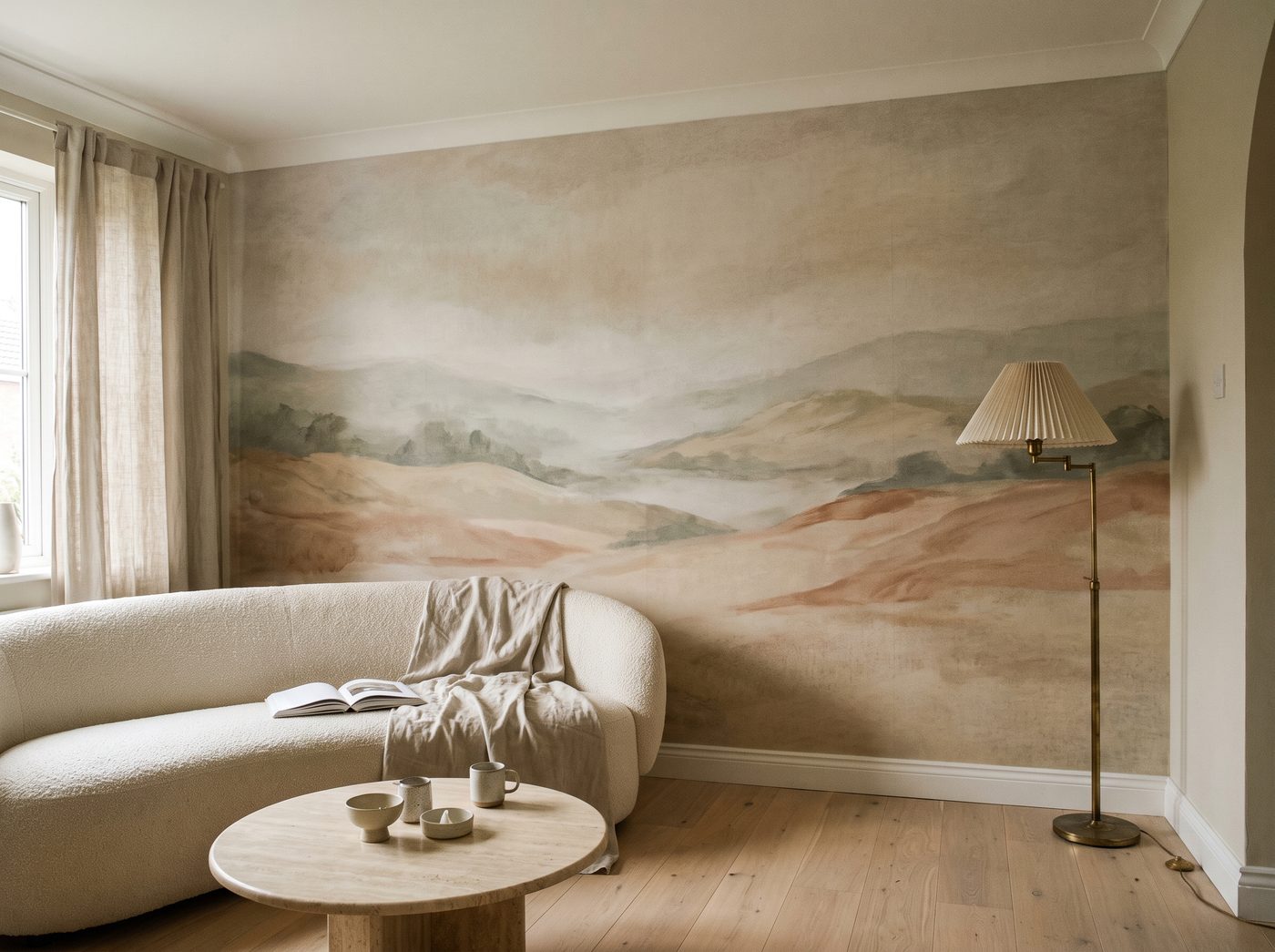 A misty landscape mural behind a low sofa in a living room